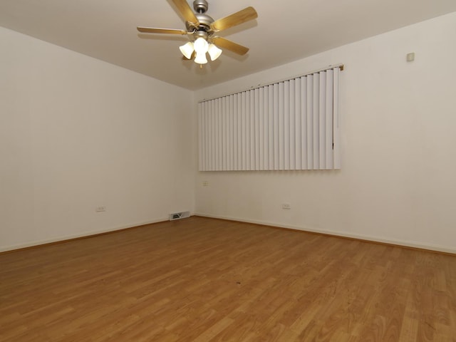 7251 S Ridgeland Ave Unit E, Chicago, IL 60649 - empty room with a ceiling fan and light wood-style floors