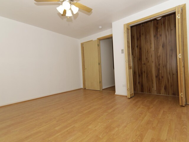 7251 S Ridgeland Ave Unit E, Chicago, IL 60649 - unfurnished bedroom featuring light wood-style flooring, a closet, and ceiling fan