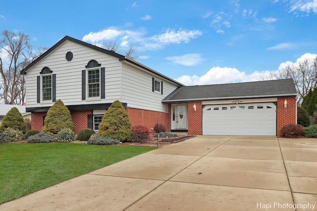 view of front facade with a front lawn and a garage