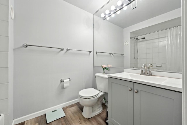 bathroom with walk in shower, vanity, wood-type flooring, and toilet