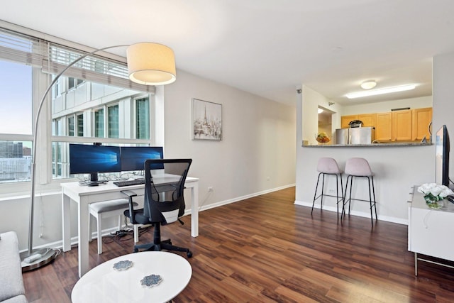 home office featuring plenty of natural light and dark hardwood / wood-style floors