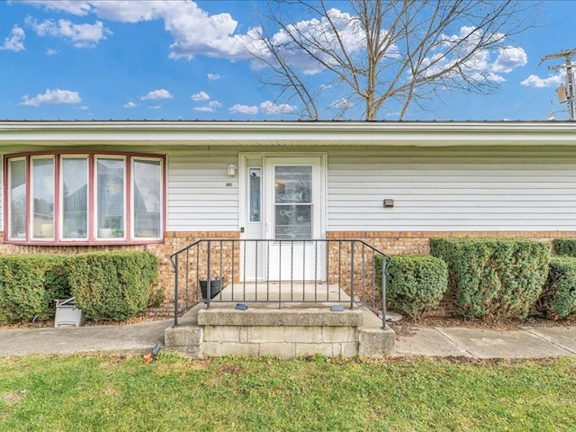 property entrance with a yard