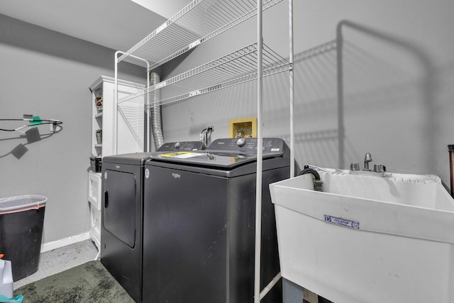 laundry area with washing machine and clothes dryer and sink