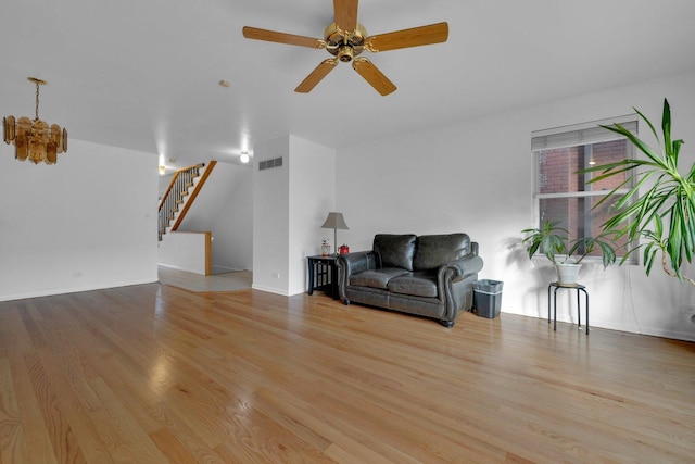 living room featuring ceiling fan and light hardwood / wood-style floors