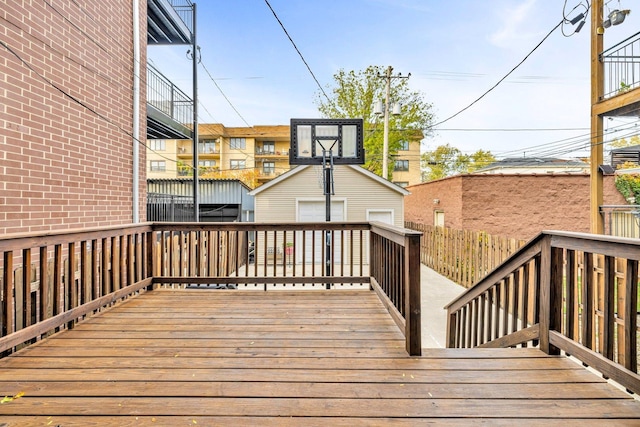 wooden deck with an outdoor structure and a garage