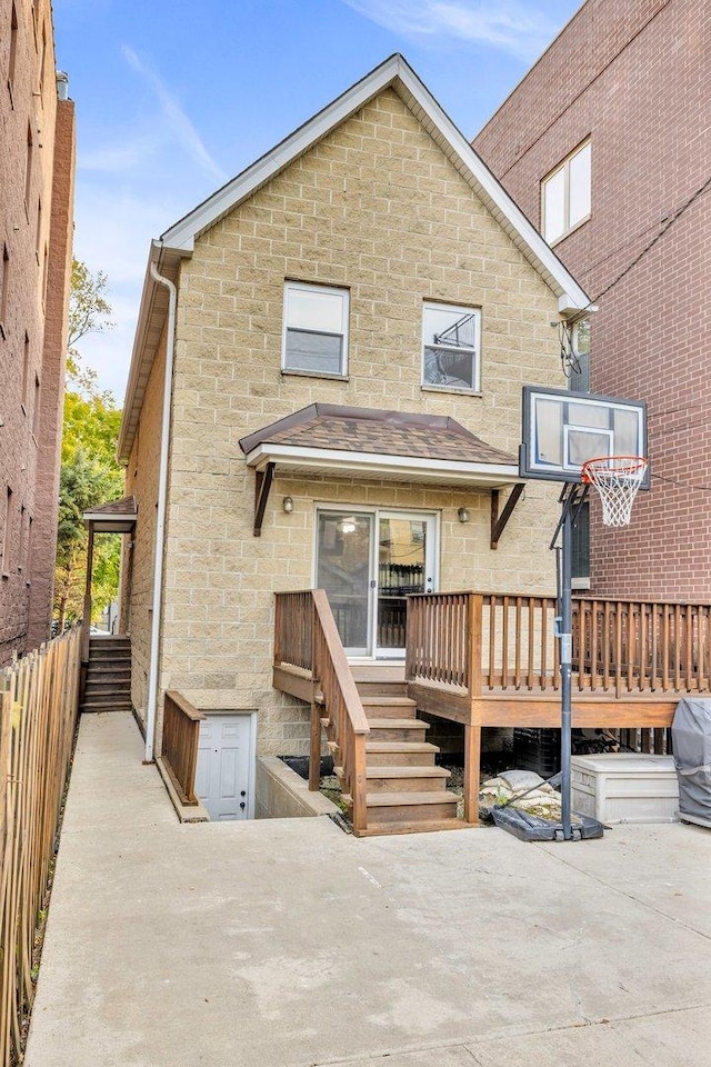 back of property featuring a wooden deck