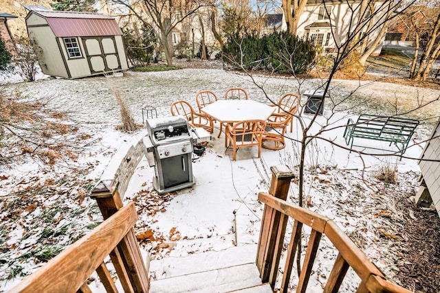 exterior space with a grill and a storage shed