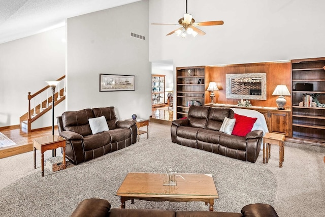 living room with high vaulted ceiling, ceiling fan, and carpet flooring