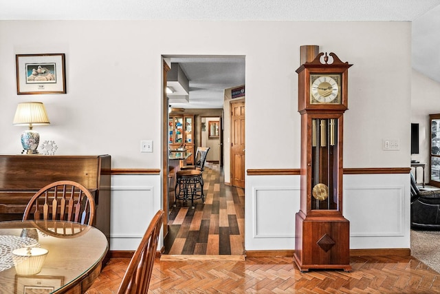 dining area with parquet floors and a textured ceiling