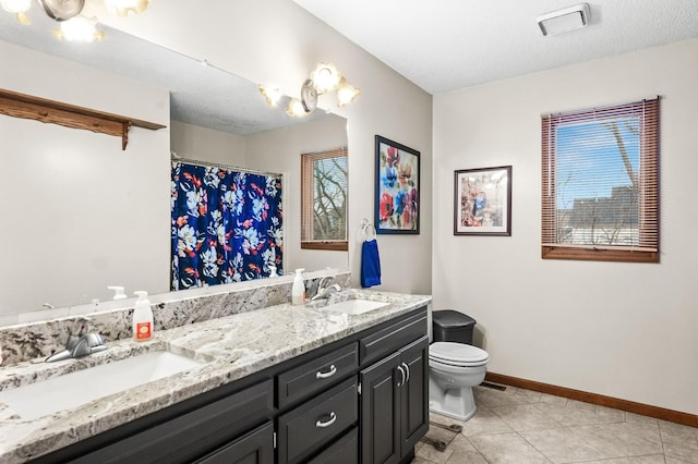 bathroom with vanity, a textured ceiling, and toilet