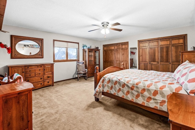 bedroom featuring light colored carpet and ceiling fan