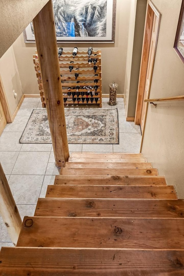 staircase featuring tile patterned flooring