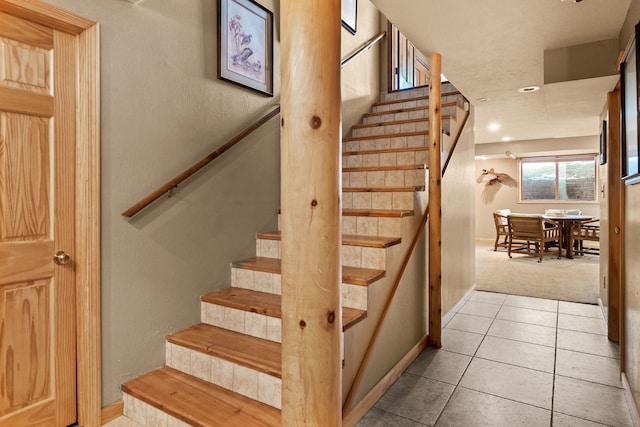 stairway featuring tile patterned floors