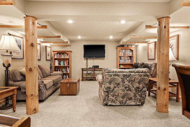 carpeted living room featuring decorative columns