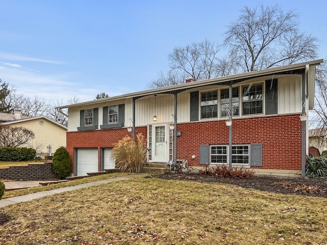 split foyer home featuring a garage and a front lawn