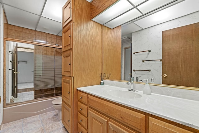 full bathroom featuring vanity, toilet, and shower / bath combination with glass door