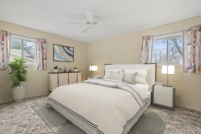 bedroom featuring ceiling fan and light carpet