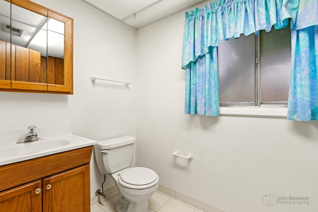 bathroom with tile patterned floors, vanity, and toilet