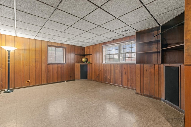 unfurnished room with a drop ceiling