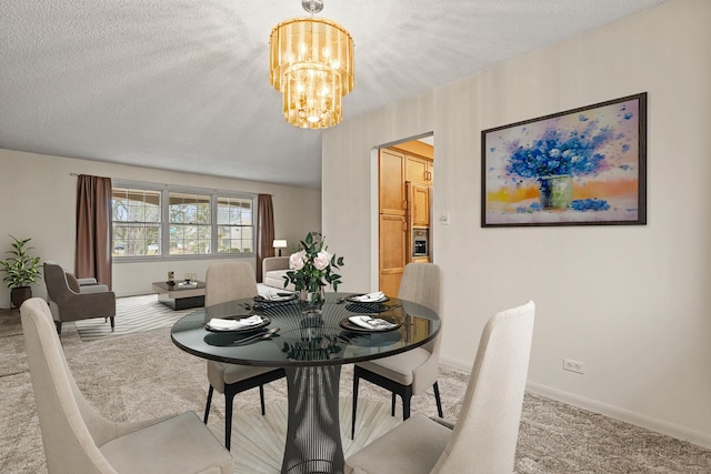 carpeted dining area featuring a textured ceiling and an inviting chandelier