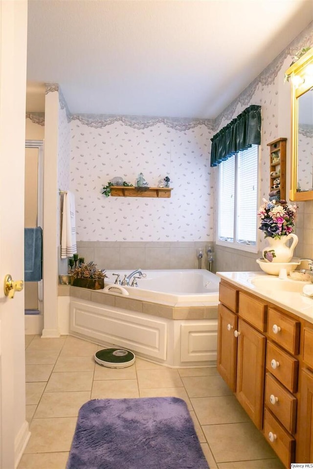 bathroom with vanity, tile patterned floors, and a tub to relax in