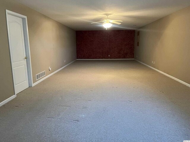 office with dark carpet and ceiling fan