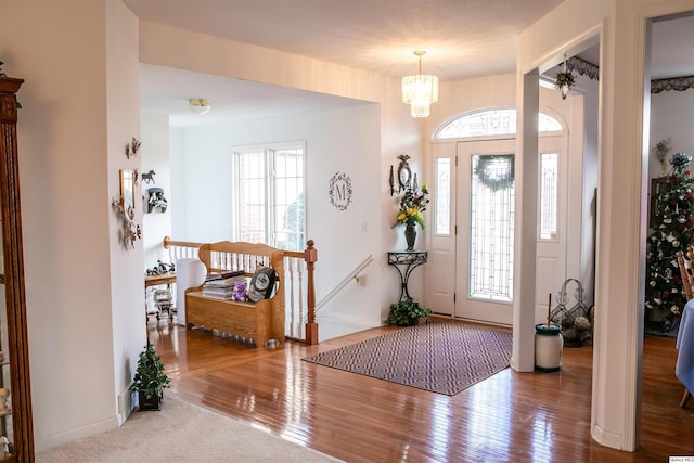 entrance foyer featuring hardwood / wood-style floors and a notable chandelier