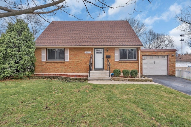 view of front of house with a garage and a front lawn