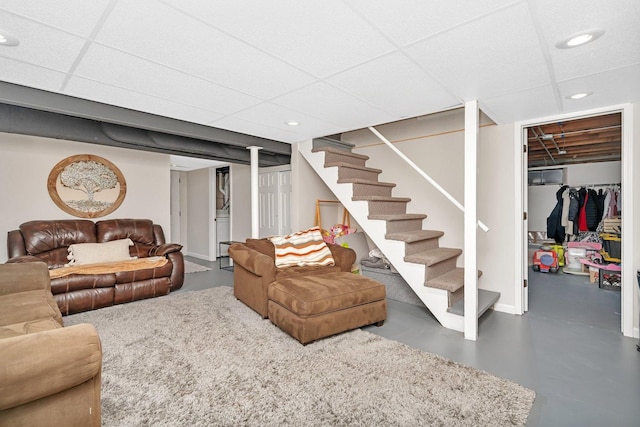 living room with a paneled ceiling