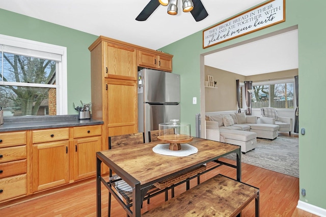 kitchen with stainless steel refrigerator, ceiling fan, light hardwood / wood-style flooring, and a healthy amount of sunlight