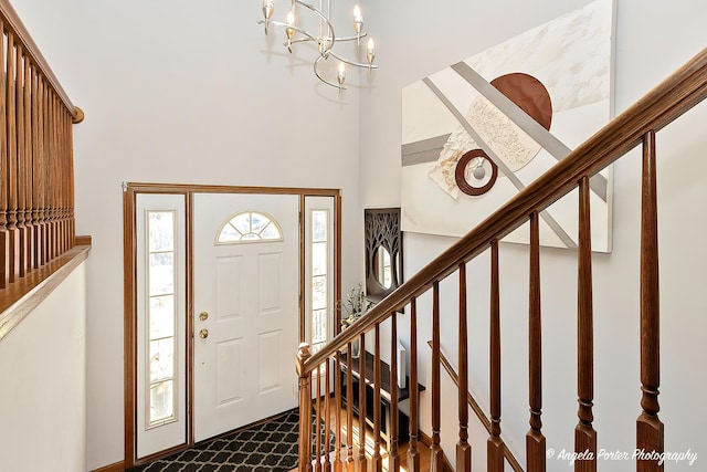 foyer entrance with a chandelier