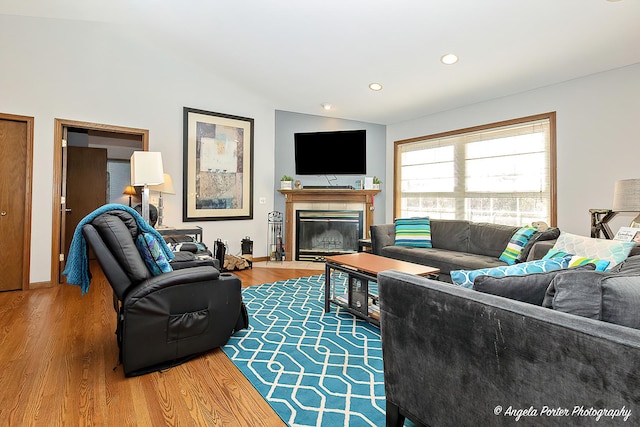 living room featuring hardwood / wood-style floors and lofted ceiling