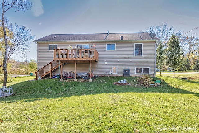 rear view of house with a lawn, cooling unit, and a deck