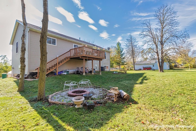 view of yard featuring a wooden deck and an outdoor fire pit