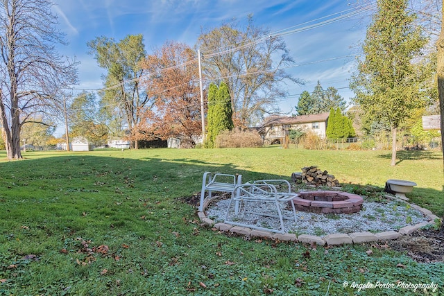 view of yard with an outdoor fire pit