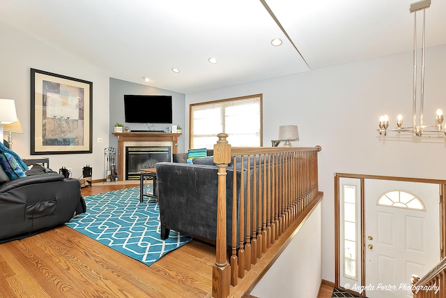 living room with a notable chandelier and hardwood / wood-style flooring