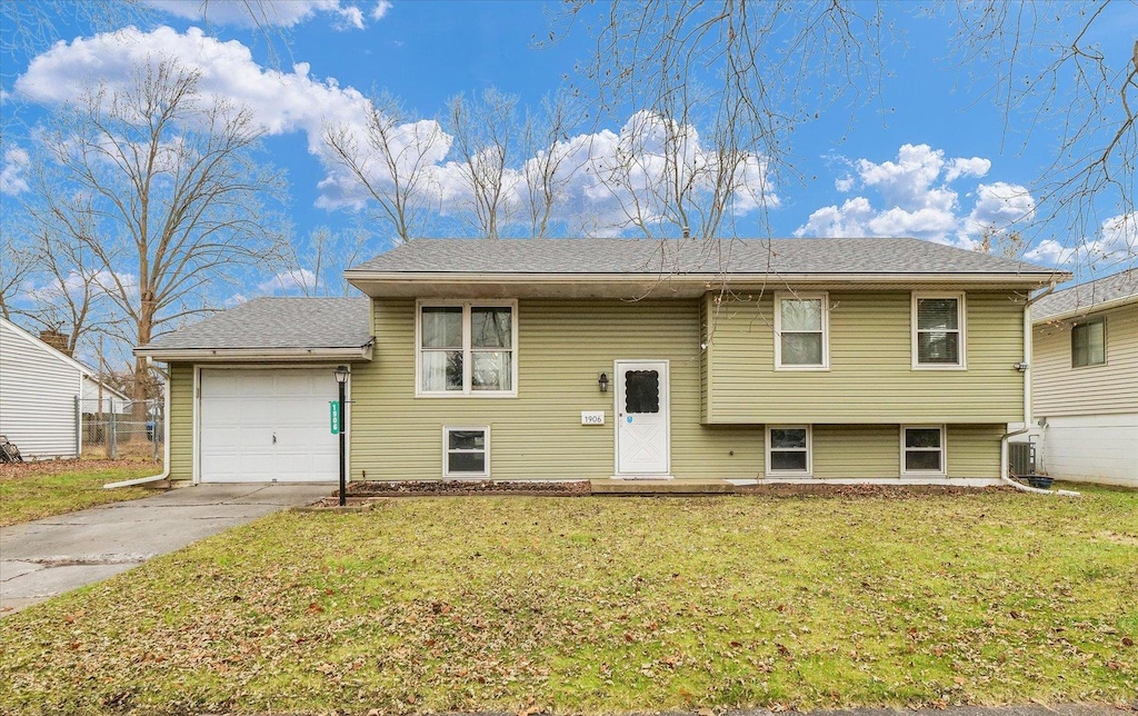 bi-level home with a front yard and a garage