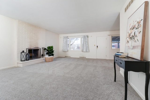 carpeted living room with a fireplace