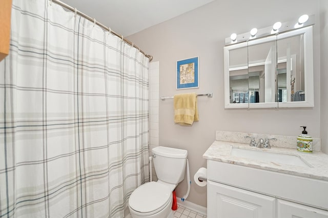 bathroom featuring toilet, vanity, and tile patterned flooring