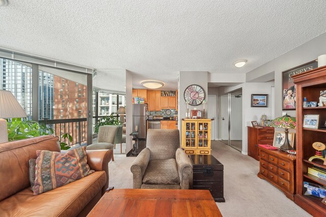 living room featuring a textured ceiling, light carpet, a wealth of natural light, and expansive windows