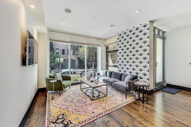 living area featuring recessed lighting, baseboards, and wood finished floors