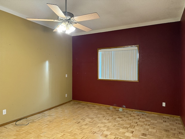 unfurnished room with ceiling fan, ornamental molding, a textured ceiling, and light parquet floors