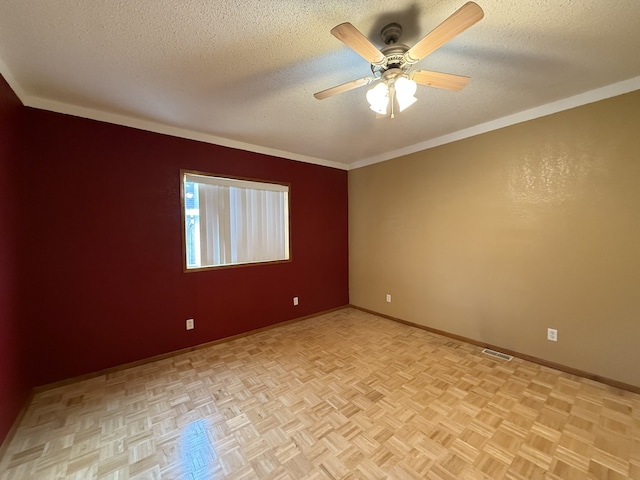 unfurnished room featuring a textured ceiling, ceiling fan, ornamental molding, and light parquet flooring