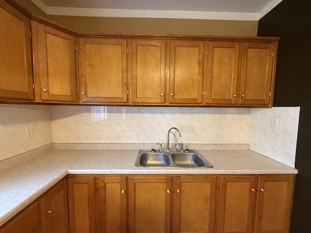 kitchen featuring decorative backsplash and sink