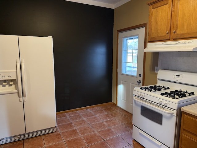 kitchen with tile patterned flooring and white appliances