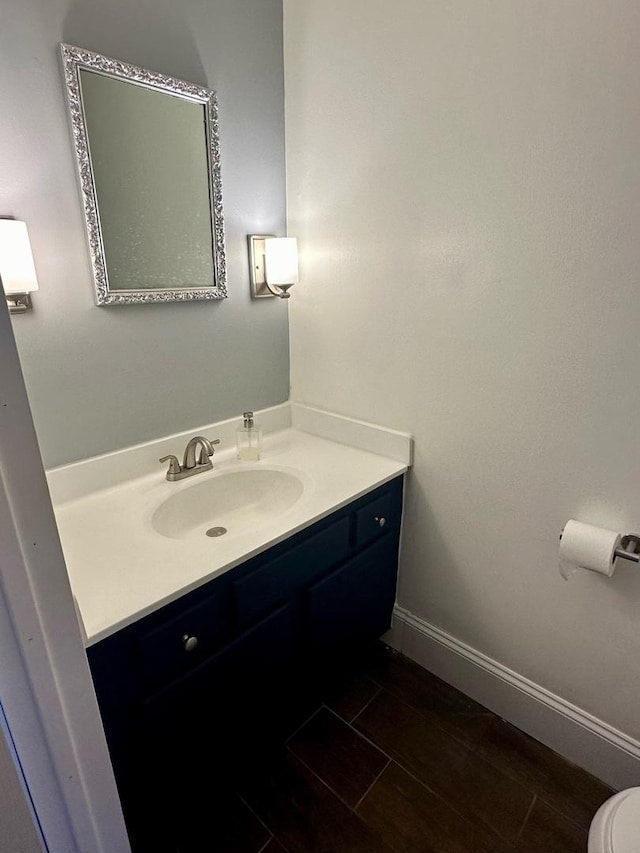 bathroom featuring tile patterned floors, vanity, and toilet