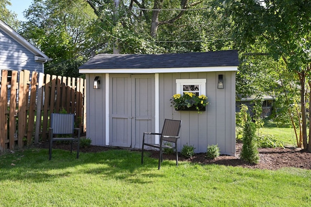 view of outbuilding with a yard