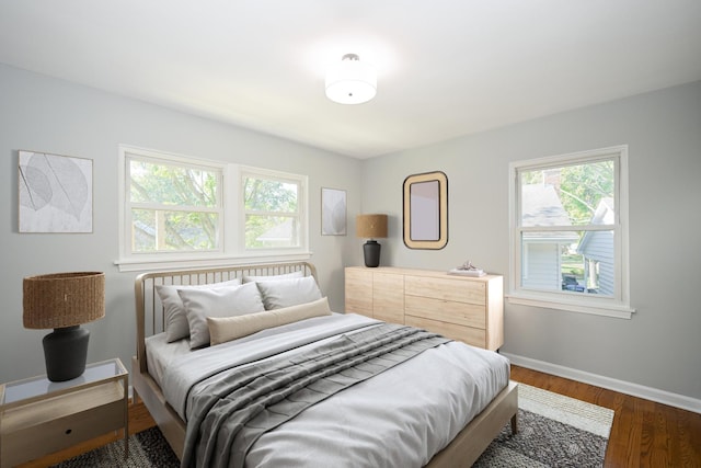 bedroom with dark hardwood / wood-style floors