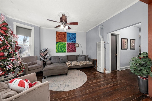 living room with ceiling fan, dark wood-type flooring, and ornamental molding