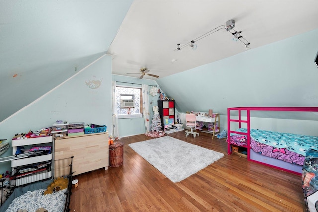 bedroom featuring ceiling fan, wood-type flooring, and vaulted ceiling